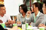 Business people working around table in office