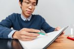 Asian student with notebook